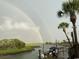 Picturesque view of a double rainbow over a waterway, highlighting palm trees and scenic beauty at 994 Oak Hollow St., Longs, SC 29568