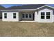Rear exterior view featuring a covered patio and multiple windows offering natural light and a relaxing outdoor space at 994 Oak Hollow St., Longs, SC 29568