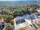 Overhead view of a light blue home with a dark roof and a surrounding forest in a rural neighborhood at 1455 Francis Marion Dr., Georgetown, SC 29440