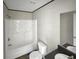 This bright bathroom features a solid-surface vanity, a shower-tub combination, and modern fixtures at 1455 Francis Marion Dr., Georgetown, SC 29440