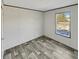This bedroom features sleek gray wood-look floors, a bright window, and neutral walls at 1455 Francis Marion Dr., Georgetown, SC 29440