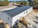 Aerial view of a single-story home with gray siding and black shutters featuring a wooden staircase at 1455 Francis Marion Dr., Georgetown, SC 29440