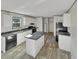 A spacious kitchen features white cabinets, a center island, black appliances, and durable gray countertops at 1455 Francis Marion Dr., Georgetown, SC 29440