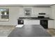 Bright kitchen with stainless steel sink, black appliances, and white cabinets with dark countertops at 1455 Francis Marion Dr., Georgetown, SC 29440