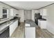 The kitchen boasts an island, black appliances, and ample cabinet space, perfect for culinary endeavors at 1455 Francis Marion Dr., Georgetown, SC 29440