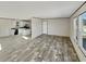 Spacious open floor plan featuring durable floors, a large window, and a kitchen in the background at 1455 Francis Marion Dr., Georgetown, SC 29440