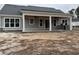 Home's backyard featuring a covered patio with an outdoor kitchen and plenty of space for entertaining at 1007 Brood Ct., Conway, SC 29526