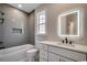 Modern bathroom featuring a bathtub, toilet, vanity, stylish fixtures, and a large mirror with appealing lighting at 1007 Brood Ct., Conway, SC 29526