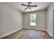 This bedroom is brightly lit, featuring hard wood floors, a ceiling fan, and a large window for great ventilation at 1007 Brood Ct., Conway, SC 29526