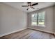This bedroom is brightly lit, featuring hard wood floors, a ceiling fan, and a large window for great ventilation at 1007 Brood Ct., Conway, SC 29526