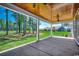 Spacious covered patio perfect for outdoor relaxation, offering scenic views of the lush green lawn and trees beyond at 1007 Brood Ct., Conway, SC 29526