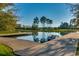 Picturesque lake view featuring a wooden dock and pontoon under a clear blue sky at 1007 Brood Ct., Conway, SC 29526