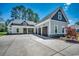Beautiful home with an extra long driveway and three car garage, set against a backdrop of trees and clear sky at 1007 Brood Ct., Conway, SC 29526