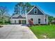 Charming two-story home with a well-manicured lawn, long driveway, and beautiful architectural details at 1007 Brood Ct., Conway, SC 29526