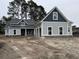 Beautiful craftsman style home with gray siding, dark trim, and a welcoming covered porch at 1007 Brood Ct., Conway, SC 29526