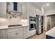 Well-equipped kitchen with stainless steel appliances, white cabinets, quartz countertops, and modern hardware at 1007 Brood Ct., Conway, SC 29526