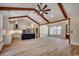 Open-concept living room with wood beams, hardwood floors, and a kitchen island with seating at 1007 Brood Ct., Conway, SC 29526
