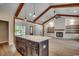 Open concept living space featuring exposed beams, a fireplace, built-in shelving, and abundant natural light at 1007 Brood Ct., Conway, SC 29526