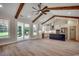 Open-concept living room with a modern kitchen, wood beams, hardwood floors, and stainless steel appliances at 1007 Brood Ct., Conway, SC 29526