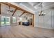 Spacious living room with high ceilings, wooden beams, hardwood floors, and an open concept kitchen at 1007 Brood Ct., Conway, SC 29526