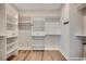 Spacious walk-in closet with custom shelves, drawers, and hanging rods to provide optimal storage and organization at 1007 Brood Ct., Conway, SC 29526