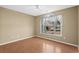 Cozy bedroom featuring wood-look flooring, ceiling fan, and a window with decorative curtains at 1021 Dunraven Ct., Conway, SC 29527