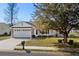 Charming home featuring a well-manicured lawn, brick accents, and an attached two-car garage at 1021 Dunraven Ct., Conway, SC 29527