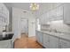 Bright kitchen features white appliances and cabinets with wood flooring at 1021 Dunraven Ct., Conway, SC 29527