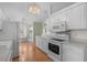 White kitchen features modern appliances, bright lighting, and an attached breakfast nook at 1021 Dunraven Ct., Conway, SC 29527