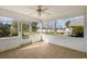 A sunroom with tile floors, white trim, and a ceiling fan offers bright, open views of the surrounding yard at 1021 Dunraven Ct., Conway, SC 29527