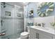 Stylish bathroom with a glass-enclosed shower, tiled walls, and a decorative vanity with a round mirror at 1031 N Dogwood Dr., Surfside Beach, SC 29575