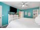 Bright bedroom with light teal walls, white furniture and ensuite bathroom at 1031 N Dogwood Dr., Surfside Beach, SC 29575