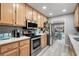 Bright kitchen features stainless steel appliances, light wood cabinets and quartz countertops at 1031 N Dogwood Dr., Surfside Beach, SC 29575