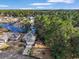 Aerial view of a home near a lake and surrounded by lush trees at 1061 Courtyard Dr., Conway, SC 29526