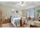 Calm bedroom with a patterned blue quilt, ceiling fan, and matching wooden nightstands at 1061 Courtyard Dr., Conway, SC 29526