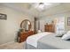 Bright bedroom with dresser and large mirror, ensuite bathroom access, and a ceiling fan at 1061 Courtyard Dr., Conway, SC 29526