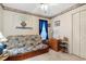 Bright bedroom with a futon, side table with lamp, and closet at 1061 Courtyard Dr., Conway, SC 29526