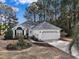 Charming single-story home with white siding, well-maintained lawn and a two-car garage at 1061 Courtyard Dr., Conway, SC 29526