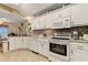 Well-lit kitchen with white cabinetry, tiled backsplash, and modern appliances at 1061 Courtyard Dr., Conway, SC 29526