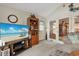 Cozy living room featuring a TV with beach scene, a wooden bookcase, and access to another room at 1061 Courtyard Dr., Conway, SC 29526