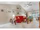 Comfortable living room showcasing neutral walls, vaulted ceiling, and a classic red sofa at 1061 Courtyard Dr., Conway, SC 29526