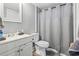 Cozy bathroom with a vanity, toilet, and shower featuring a gray shower curtain, creating a functional space at 109 Clemson Rd., Conway, SC 29526