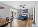 Bright bedroom with wood floors, a ceiling fan, and access to an outdoor deck through glass doors at 109 Clemson Rd., Conway, SC 29526