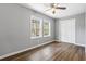 Clean bedroom with wood floors, two large windows, and a closet, providing a comfortable living space at 109 Clemson Rd., Conway, SC 29526