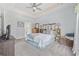 Spacious bedroom featuring a tray ceiling, bed with rustic headboard, dresser, and access to the bathroom at 109 Jessica Lakes Dr., Conway, SC 29526