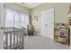 Charming Bedroom with a gray crib, a decorative rocking chair, and a large window with patterned curtains at 109 Jessica Lakes Dr., Conway, SC 29526