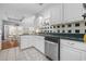 Well-lit kitchen features white cabinetry, stainless steel appliances, and a breakfast nook at 109 Jessica Lakes Dr., Conway, SC 29526