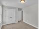 Neutral-toned bedroom with double closet boasts carpeted flooring and a light fixture at 1091 Forest Bend Dr., Calabash, NC 28467