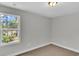 Neutral bedroom with a window overlooking the woods features carpeted floors and neutral walls at 1091 Forest Bend Dr., Calabash, NC 28467