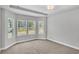 Light-filled bedroom boasts neutral walls, plush carpet and large windows showcasing the outdoor view at 1091 Forest Bend Dr., Calabash, NC 28467